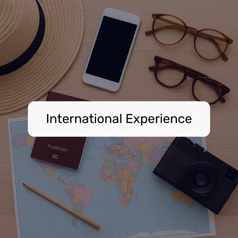 Straw hat, smartphone, glasses, passport, pencil, map, and camera on a desk with the label "International Experience."
